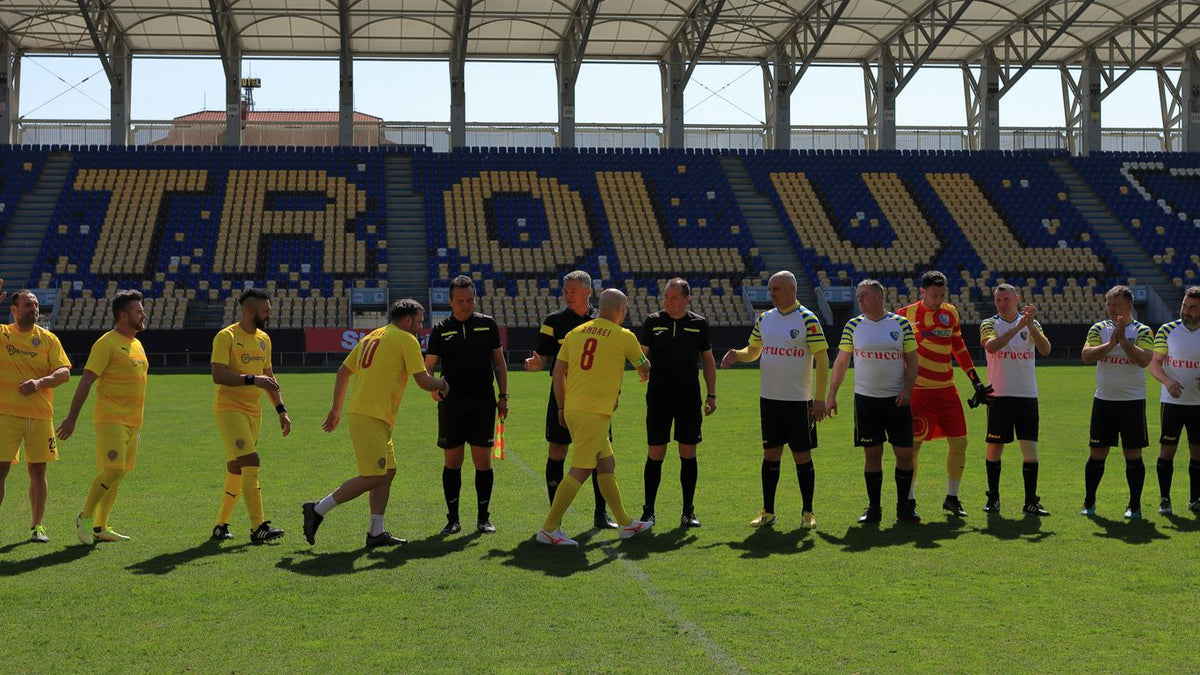 A group of men standing on top of a soccer field